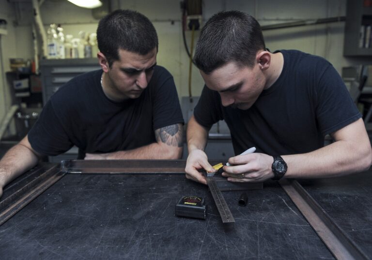 U.S. Navy Aviation Structural Mechanic 3rd Class Hunter McLane, right, and Aviation Structural Mechanic 3rd Class Carlos Gallardo measure a piece of steel for a brace in the airframe shop aboard the aircraft carrier USS Nimitz (CVN 68) in the Gulf of Oman June 18, 2013. The Nimitz Strike Group deployed to the U.S. 5th Fleet area of responsibility conducting maritime security operations, theater security cooperation efforts and support missions for Operation Enduring Freedom.