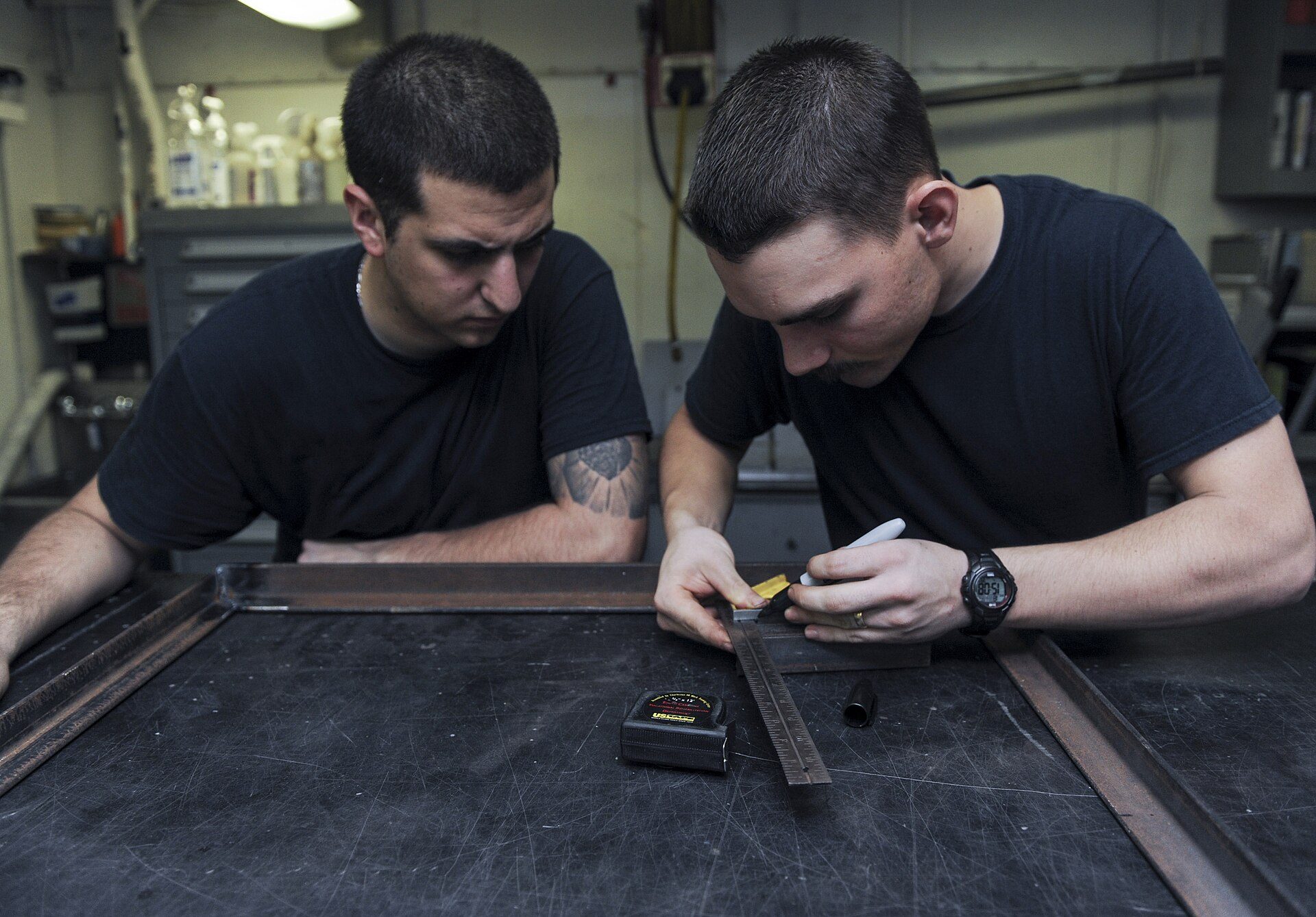 U.S. Navy Aviation Structural Mechanic 3rd Class Hunter McLane, right, and Aviation Structural Mechanic 3rd Class Carlos Gallardo measure a piece of steel for a brace in the airframe shop aboard the aircraft carrier USS Nimitz (CVN 68) in the Gulf of Oman June 18, 2013. The Nimitz Strike Group deployed to the U.S. 5th Fleet area of responsibility conducting maritime security operations, theater security cooperation efforts and support missions for Operation Enduring Freedom.